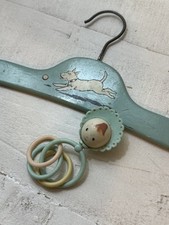 vintage 1930s to 1940s Art Deco wooden child's clothes hanger and baby rattle picture