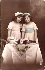 PORTRAIT OF TWO ADORABLE GIRLS : HAVING TEA AND CAKE : ALFRED NOYER :  (1916) picture