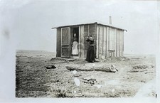 Pioneer shack in old west woman w rifle 1910 RPPC Photo Postcard COPY picture