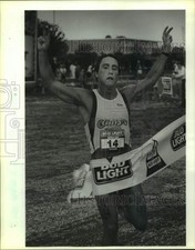 1991 Press Photo Triathlon runner Louis Murphy crosses the finish line in first picture