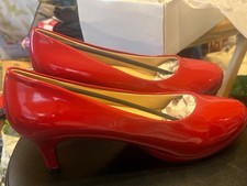 Angel Steps Pumps Feature A Vibrant Red Patent Leather Finish And A Low Heel picture