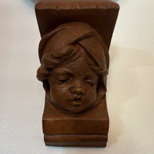 20th century French chubby faced terracotta cherub wall bracket signed “Curl”.  picture