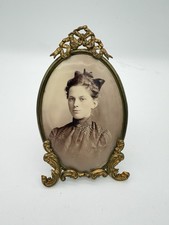 Antique oval picture frame ornate brass scrolling top ribbon accent  picture