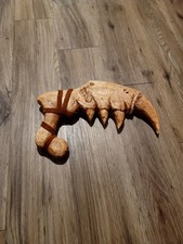 This is a genuine hand carved wooden claw dagger with brown leather straps.... picture