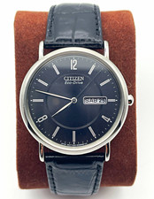 Citizen Eco-Drive Men's Dual Language Day/Date Black Dial Silver Case picture