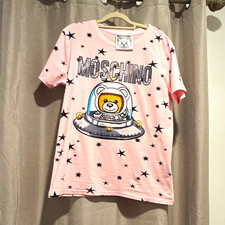 Women’s pink T-shirt featuring a cute teddy bear astronaut design with stars. picture