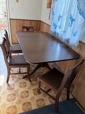Vintage dark-wood Duncan Phyfe dining table and matching chairs featuring picture