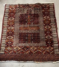 Antique Turkmen hand-knotted wool rug features a traditional 