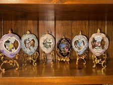 Set of six Fabergé-style porcelain eggs, each with a hand-painted 3D songbird picture