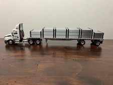 DCP First Gear 1/64th Bison Transport Cascadia Day Cab and 48' Flatbed with Load picture