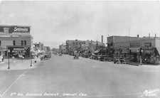 H32/ Greeley Colorado RPPC Postcard c1940s 8th Ave Business Stores Autos picture