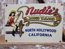 VINTAGE NUDIES PORCELAIN SIGN RARE OLD RODEO TAILOR HOLLYWOOD CALIFORNIA COWGIRL picture