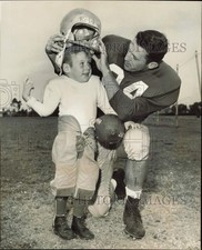 1959 Press Photo Bob Rosbaugh puts helmet on Easter Seal Prince Richard Clark picture