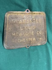 antique cast-iron access door or nameplate from a Guarantee Liquid Measure Co. picture