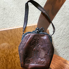 vintage brown leather handbag featuring an ornate hand-tooled floral design picture